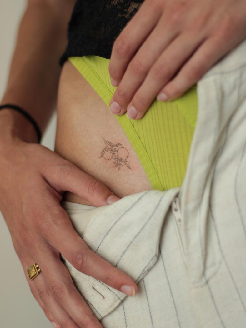 Fine line tiny tattoo by queer artist in lisbon