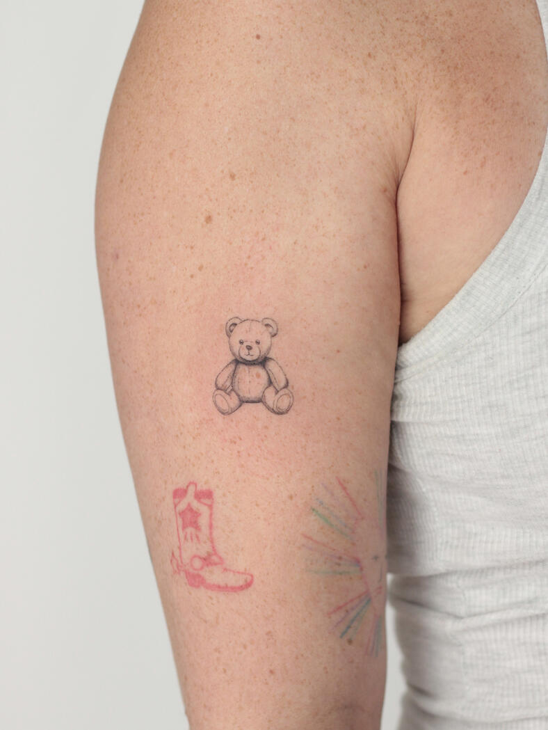 Fineline teddy bear tattoo by queer artist in lisbon